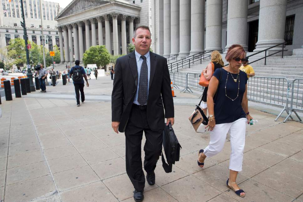 In this  July 13, 2016 photo, retired New York Police Department Sgt. Ronald Buell, center, leaves federal district court in Manhattan. Buell received probation for selling National Crime and Information Center information to a private investigator for defense attorneys. At his sentencing, Buell said he hoped other officers would learn "to never put themselves in the position I'm in." (AP Photo/Mary Altaffer)