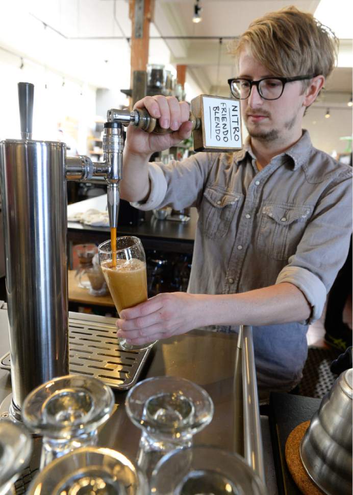 Francisco Kjolseth  |  The Salt Lake Tribune
Cody Kirkland, Cafe Manager at the Rose Establishment, serves up a glass of Nitro Coffee. Several Salt Lake City coffee shops serve the cold-brewed coffee, that has been kegged (with nitrogen and CO-2) and then served on tap like a beer.