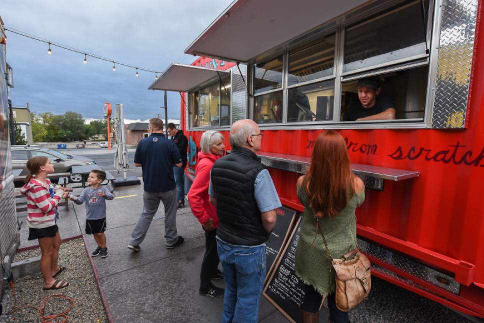 Francisco Kjolseth | The Salt Lake Tribune
Alex Schenck of Komrades food truck takes orders of their popular European-style street food recently at the Soho Food Park in Holladay. Food truck owners often need to navigate confusing governmental regulations from city to city. The Soho Food Park is an example of how one city has made it more convenient for food trucks to operate.