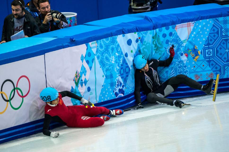 J.R. Celski, of Salt Lake City, and Dequan Chen, of China, (208) fall after finishing in the 1,500-meter short-track speedskating finals at Iceberg Skating Palace during the 2014 Sochi Olympic Games Monday February 10, 2014. Celski finished in fourth place with a time of 2:15.624, 0.639 behind gold medalist Charles Hamelin of Canada. (Photo by Chris Detrick/The Salt Lake Tribune)
