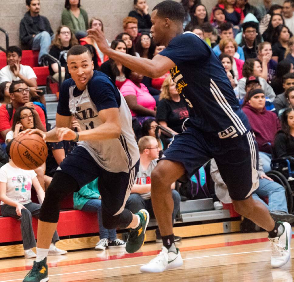 Rick Egan  |  The Salt Lake Tribune

Dante Exum (11) brings the ball down the court, as Rodney Hood (5)defends, as the Utah Jazz play a surprise scrimmage at Granger High School, Friday, September 30, 2016.