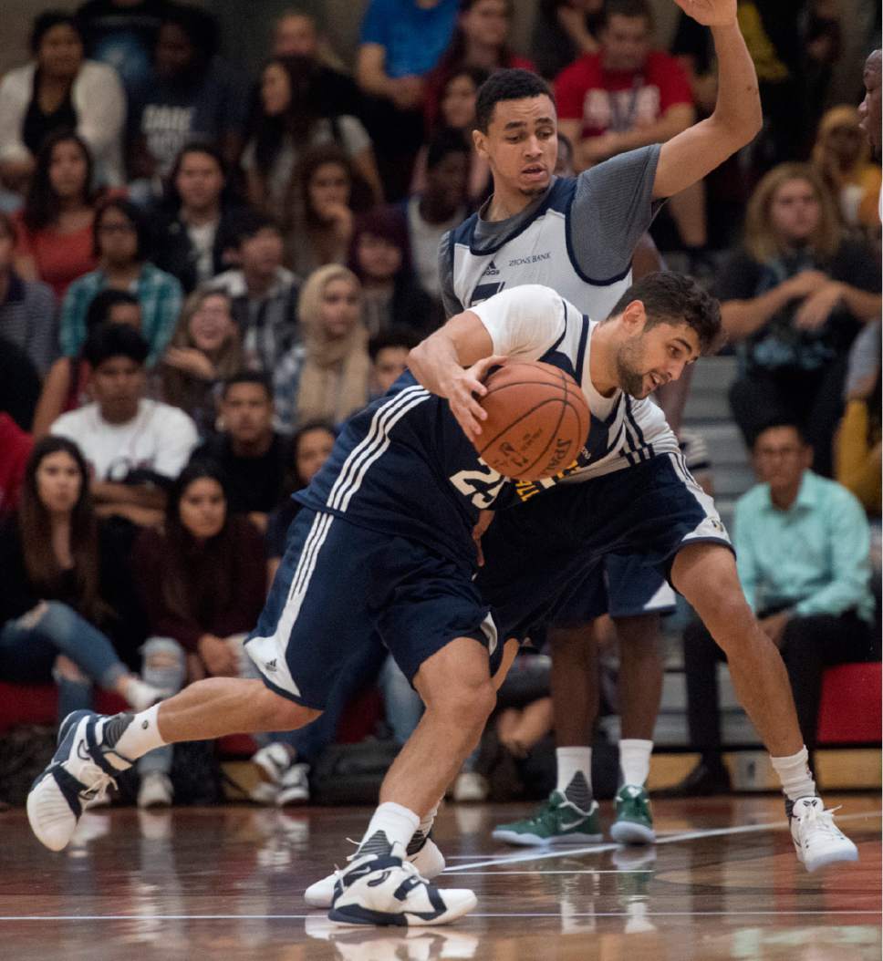Rick Egan  |  The Salt Lake Tribune

Raul Neto (25) tries to get past Marcus Paige(16), as the Utah Jazz play a surprise scrimmage at Granger High School, Friday, September 30, 2016.