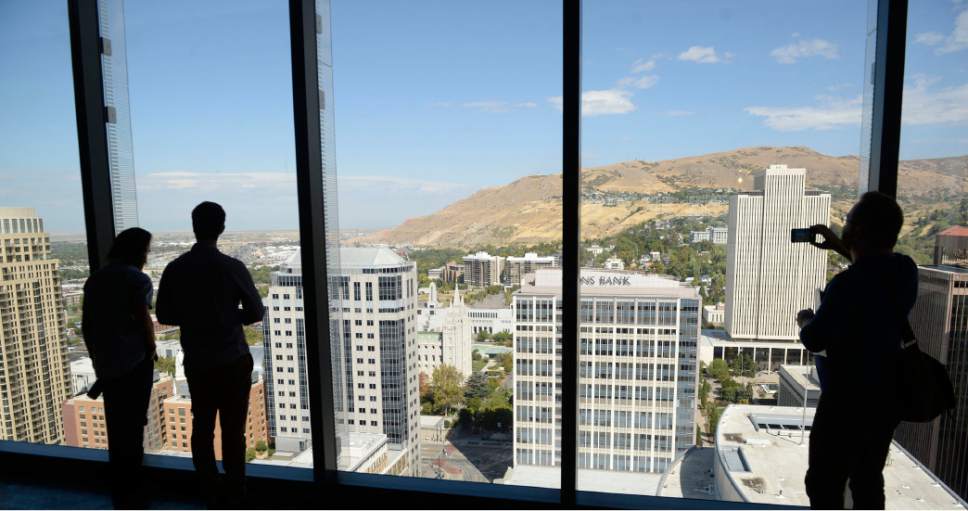 Al Hartmann  |  The Salt Lake Tribune
Guests take in the breath taking view of Main Street from the top floor north windows of Salt Lake Cityís new premier office tower, 111 Main on Thursday September 22.