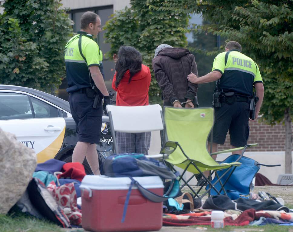 Al Hartmann  |  The Salt Lake Tribune
Salt Lake City Police check identifications and made arrests in a sweep of the Rio Grande neighborhood in downtown Salt Lake City Thursday September 29.  Here they handcuff a man on the block of 500 West between 300 and 400 South where many homeless spend time during the day in lawn chairs, sleeping bags and their suitcases.