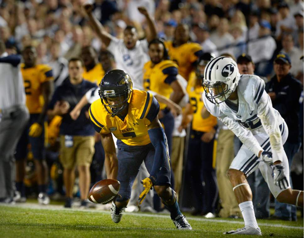 Scott Sommerdorf   |  The Salt Lake Tribune  
Toledo Rockets wide receiver Jon'Vea Johnson (7) drops a pass late in the first half with BYU defensive back Chris Wilcox (32) defending during first half play. BYU and Toledo were tied 21-21 at the half, Friday, September 30, 2016.