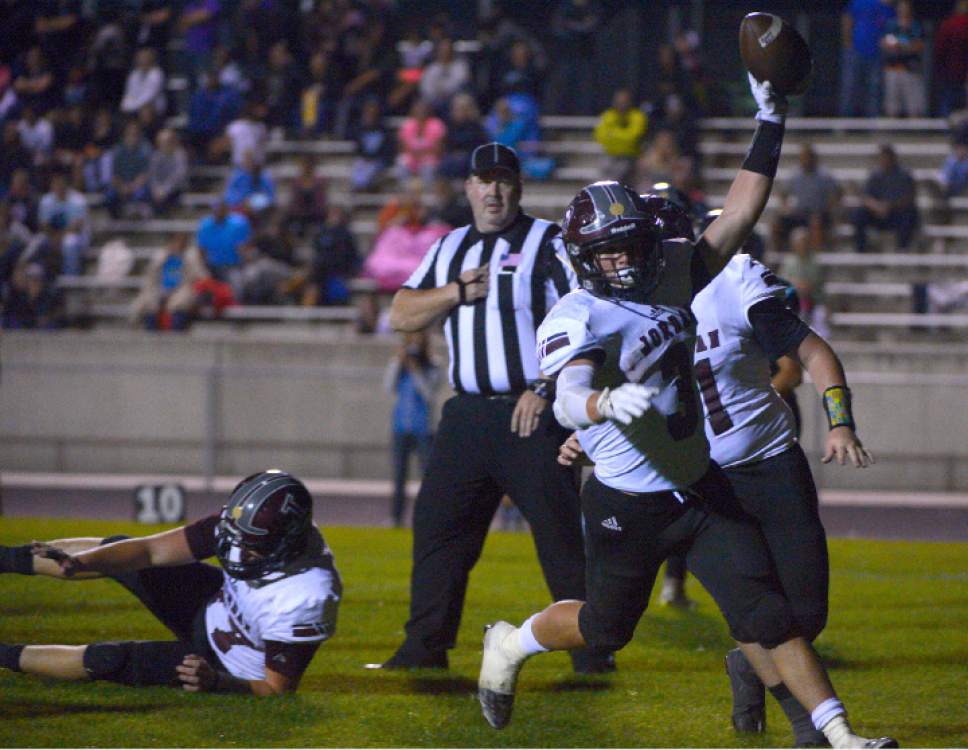 Leah Hogsten  |  The Salt Lake Tribune
Jordan's Jake Shaver with the final touchdown. Jordan High School defeated West Jordan High School football team 41-35 in their Region 3 football game, September 30, 2016.