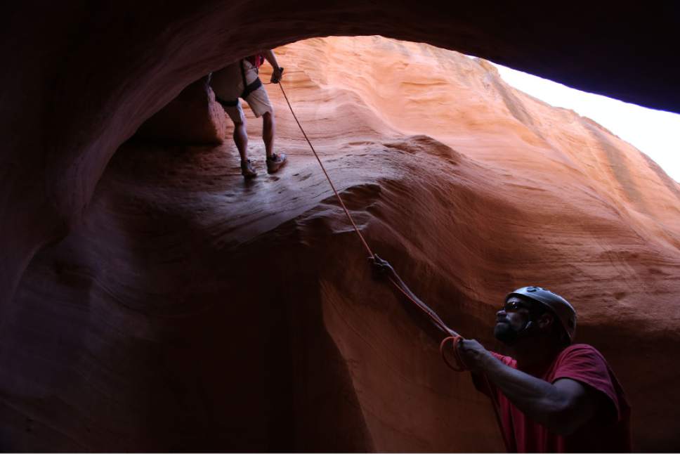 Francisco Kjolseth  |  The Salt Lake Tribune
Guide Jim Clery acts as a back up belay while Gary Turnier navigates a tricky spot in a slot canyon in the Grand Staircase-Escalante National Monument.
