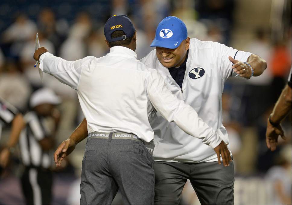 BYU coach Kalani Sitake, right, greets a Toldeo coaching acquaintance before an NCAA college football game Friday, Sept. 30, 2016, in Provo, Utah. (Scott Sommerdorf/The Salt Lake Tribune via AP)