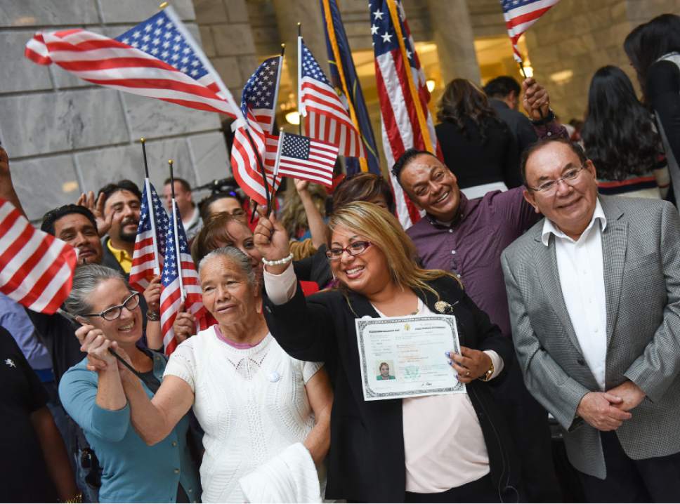 Francisco Kjolseth | The Salt Lake Tribune
Claudia Gonzalez of Mexico is surrounded by family as she proudly holds her new certificate of U.S. Citizenship following a naturalization ceremony at the Utah Capitol on Friday, Sept. 30, 2016.