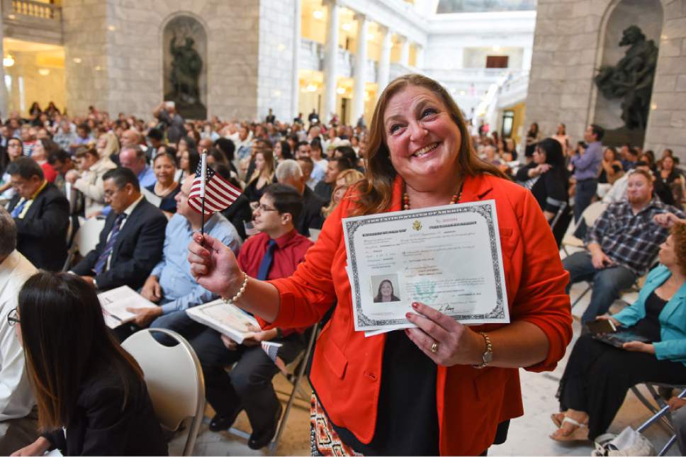 Francisco Kjolseth | The Salt Lake Tribune
Carri Koon of England proudly holds her new certificate of U.S. Citizenship during a ceremony at the Utah state Capitol on Friday, Sept. 30, 2016. The U.S. Citizenship and Immigration Services hosted a naturalization ceremony for 132 citizenship applicants from 49 countries.
