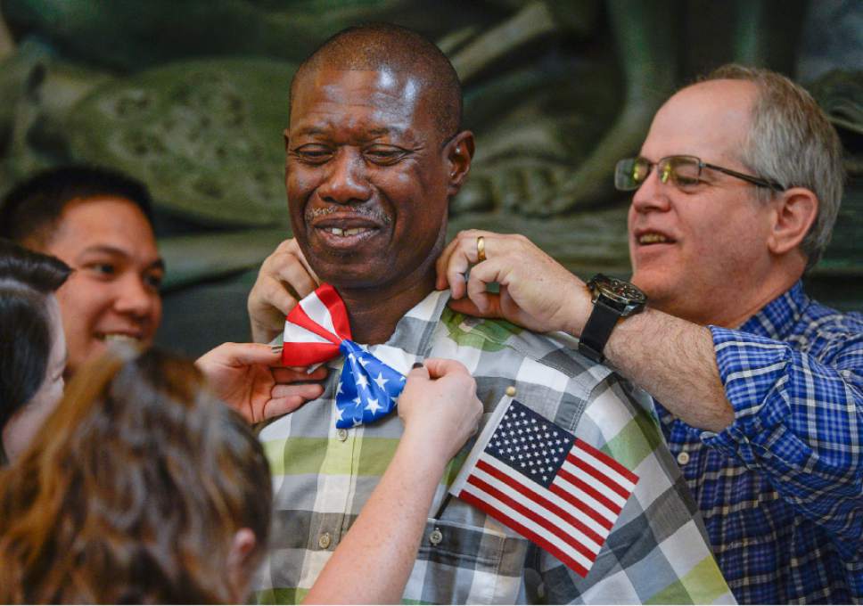 Francisco Kjolseth  |  The Salt Lake Tribune
Jerry Flowers of Belize has his bow tie adjusted by friends following a naturalization ceremony by the U.S. Citizenship and Immigration Services for 132 citizenship applicants from 49 countries at the Utah Capitol on Friday, Sept. 30, 2016.