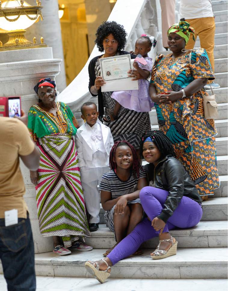 Francisco Kjolseth | The Salt Lake Tribune
Rose Ndayishimiye of Burundi, center top, gathers with family for a photo following a naturalization ceremony at the Utah Capitol where 132 citizen applicants from 49 countries became U.S. Citizens on Friday, Sept. 30, 2016.