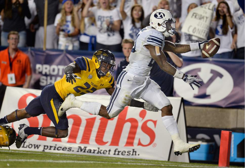 Scott Sommerdorf   |  The Salt Lake Tribune  
BYU RB Jamaal Williams (21) stretches for his fourth TD of his five TD runs as BYU defeated Toledo 55-53, Friday, September 30, 2016. Williams finished with a BYU record for total yards rushing with 286.
