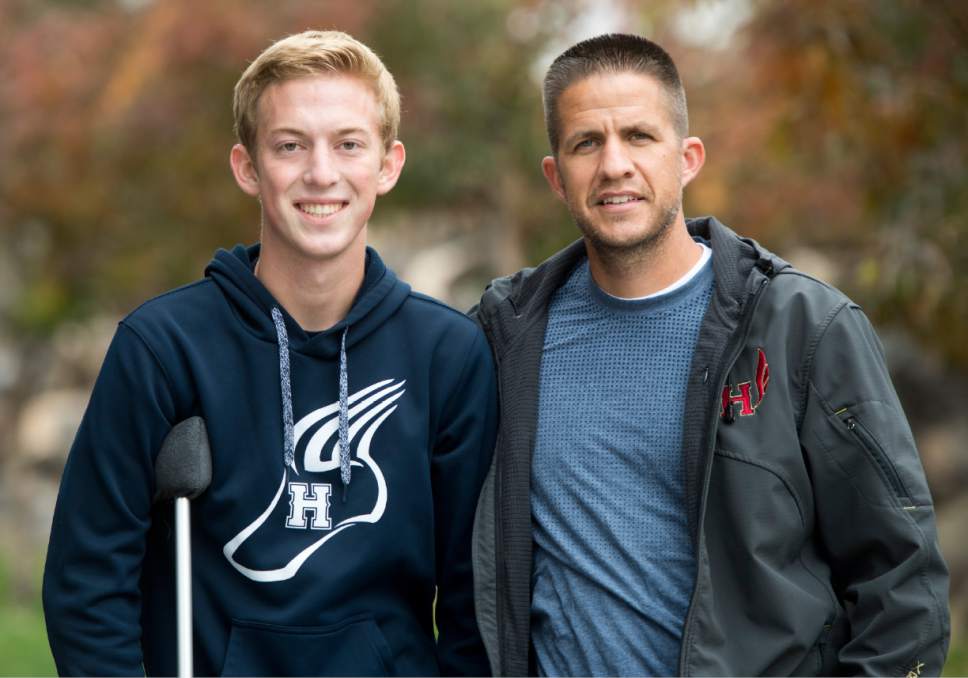 Rick Egan  |  The Salt Lake Tribune

Herman High School cross country runner, Bryan Fugal with Herriman's cross country coach, James Barnes.  Barnes saved several of his players from an oncoming truck, Fugal was actually struck and broke his leg, which ended his senior season.
Monday, October 3, 2016.