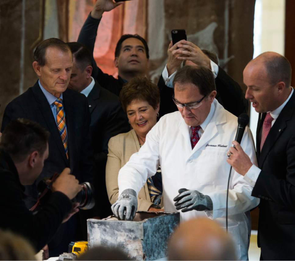 Steve Griffin / The Salt Lake Tribune


After using a power snipper to cut open the copper time capsule Gov. Gary Herbert  removes items from the box that was placed in the State Capitol in April 1914, during a ceremony at the Capitol Rotunda in Salt Lake City Monday October 3, 2016.