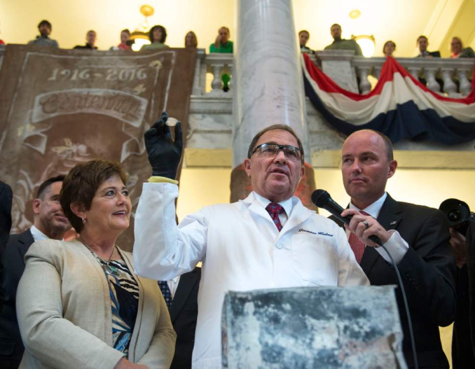 Steve Griffin  |  The Salt Lake Tribune
After using a power snipper to cut open the copper time capsule Gov. Gary Herbert  removes a silver dollar from the box that was placed in the State Capitol in April 1914, during a ceremony at the Capitol Rotunda in Salt Lake City Monday October 3, 2016.