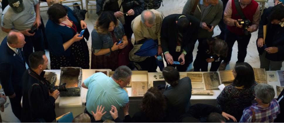 Steve Griffin / The Salt Lake Tribune


People use their cell phones to photograph historic items removed from a copper time capsule that was placed in the State Capitol in April 1914. Gov. Gary Herbert removed the items during a ceremony at the Capitol Rotunda in Salt Lake City Monday October 3, 2016.
