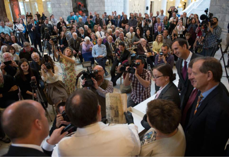Steve Griffin / The Salt Lake Tribune


After using a power snipper to cut open the copper time capsule Gov. Gary Herbert  removes items from the box that was placed in the State Capitol in April 1914, during a ceremony at the Capitol Rotunda in Salt Lake City Monday October 3, 2016.