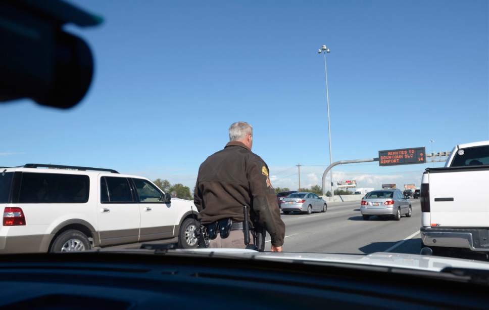 Al Hartmann  |  The Salt Lake Tribune
UHP Sgt. Danny Allen looks for cars illegally using the HOV lanes along I-15 in Salt Lake valley Wednesday Oct. 6.  Utah Department of Transportation and Utah Highway Patrol are partnering and launching an enforcement blitz to educate drivers how to correctly use the express lanes.  He approaches the white truck, right, which was using the HOV lane with only a driver.  The driver got a ticket. Utah's Express Lanes are the longest continuous in the country stretching 72 miles from Layton to Spanish Fork.