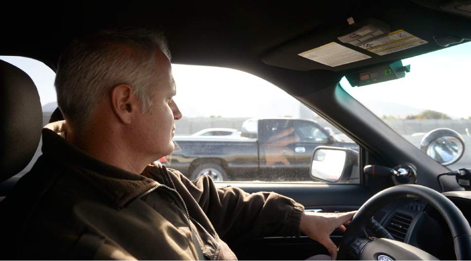 Al Hartmann  |  The Salt Lake Tribune
UHP Sgt. Danny Allen looks for cars illegally using the HOV lanes along I-15 in Salt Lake valley Wednesday Oct. 6. He counts to see if there are two passengers of a passing pickup in the HOV lane. This truck was fine.  Utah Department of Transportation and Utah Highway Patrol are partnering and launching an enforcement blitz to educate drivers how to correctly use the express lanes.  Utah's Express Lanes are the longest continuous in the country stretching 72 miles from Layton to Spanish Fork.