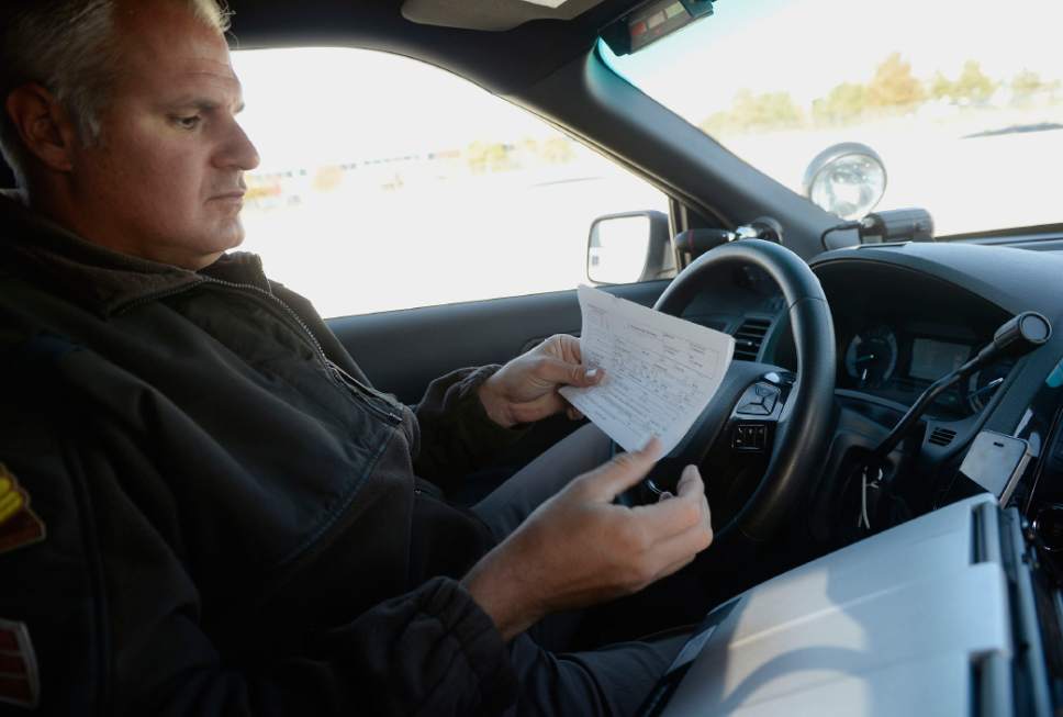 Al Hartmann  |  The Salt Lake Tribune
UHP Sgt. Danny Allen looks for cars illegally using the HOV lanes along I-15 in Salt Lake valley Wednesday Oct. 6.  He prints out a ticket for a truck he pulled over for incorrect use of the HOV lane. Utah Department of Transportation and Utah Highway Patrol are partnering and launching an enforcement blitz to educate drivers how to correctly use the express lanes.  Utah's Express Lanes are the longest continuous in the country stretching 72 miles from Layton to Spanish Fork.
