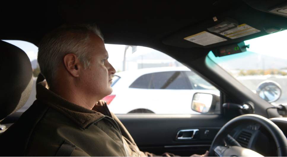 Al Hartmann  |  The Salt Lake Tribune
UHP Sgt. Danny Allen looks for cars illegally using the HOV lanes along I-15 in Salt Lake valley Wednesday Oct. 6. He counts to see if there are two passengers of a passing SUV in the HOV lane. Tinted windows make the job tougher.  Utah Department of Transportation and Utah Highway Patrol are partnering and launching an enforcement blitz to educate drivers how to correctly use the express lanes.  Utah's Express Lanes are the longest continuous in the country stretching 72 miles from Layton to Spanish Fork.