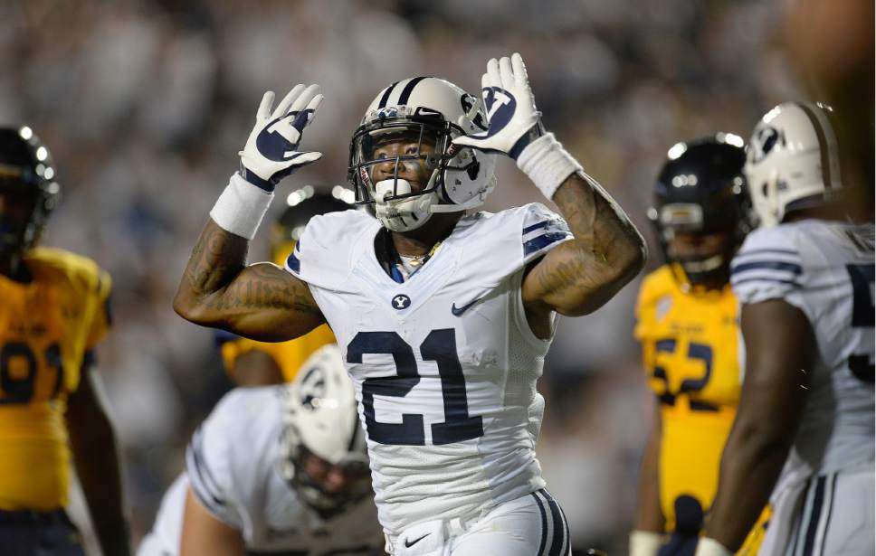 BYU running back Jamaal Williams celebrates after scoring a touchdown against Toledo late in the first quarter of an NCAA college football game Friday, Sept. 30, 2016, in Provo, Utah. (Scott Sommerdorf/The Salt Lake Tribune via AP)