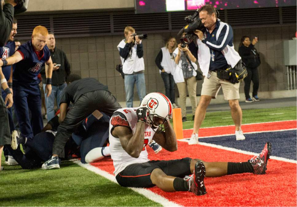 Rick Egan  |  The Salt Lake Tribune

Utah Utes wide receiver Kenneth Scott (2), sits in the endzone, after the Utes failed to score on the last play of the game, as the Wildcats celebrate their 37-30 win over the Utes in double overtime, in PAC-12 action against the Arizona Wildcats, in Tucson, Saturday, November 14, 2015.