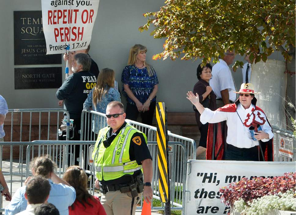 Scott Sommerdorf   |  The Salt Lake Tribune  
A man dressed like the Devil waved at conference attendees as they left the morning session of 186th Semiannual General Conference of the LDS church last week.