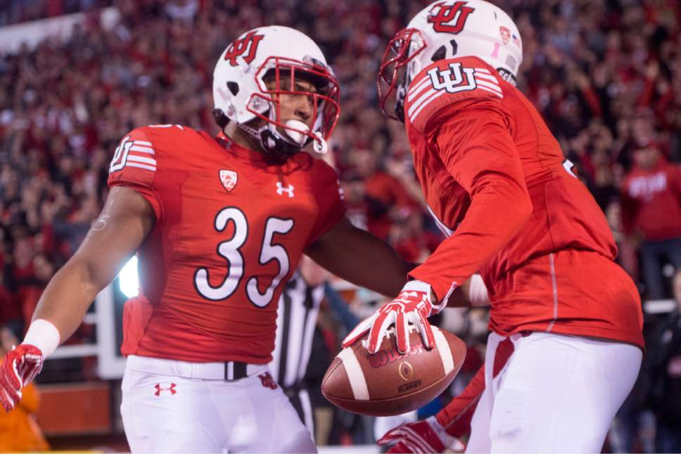 Rick Egan  |  The Salt Lake Tribune

Utah Utes running back Jordan Howard (35) celebrates with Tyrone Smith (21) after Smith's touchdown, in PAC-12 football action, Utah vs. The Arizona Wildcats, at Rice-Eccles Stadium, Saturday, October 8, 2016.