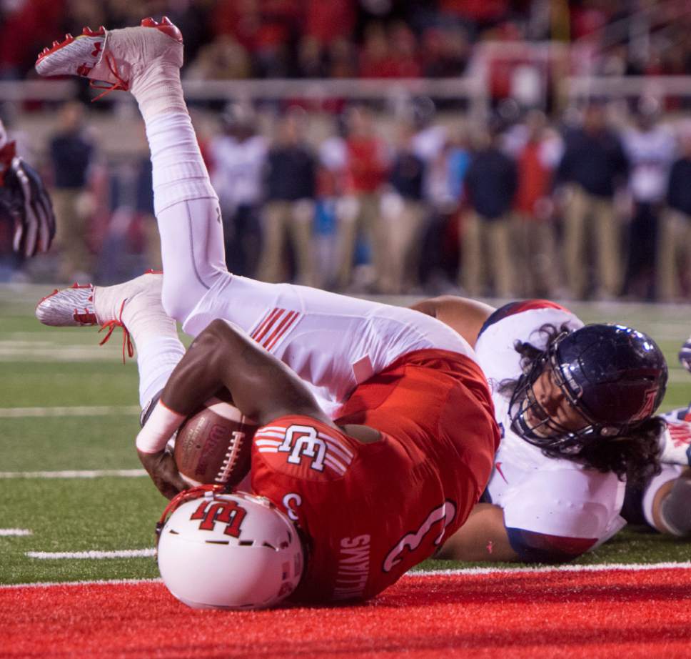 Rick Egan  |  The Salt Lake Tribune

Utah quarterback Troy Williams (3) tumbles into the end zone for a touchdown for the Utes, in PAC-12 football action, Utah vs. The Arizona Wildcats, at Rice-Eccles Stadium, Saturday, October 8, 2016.