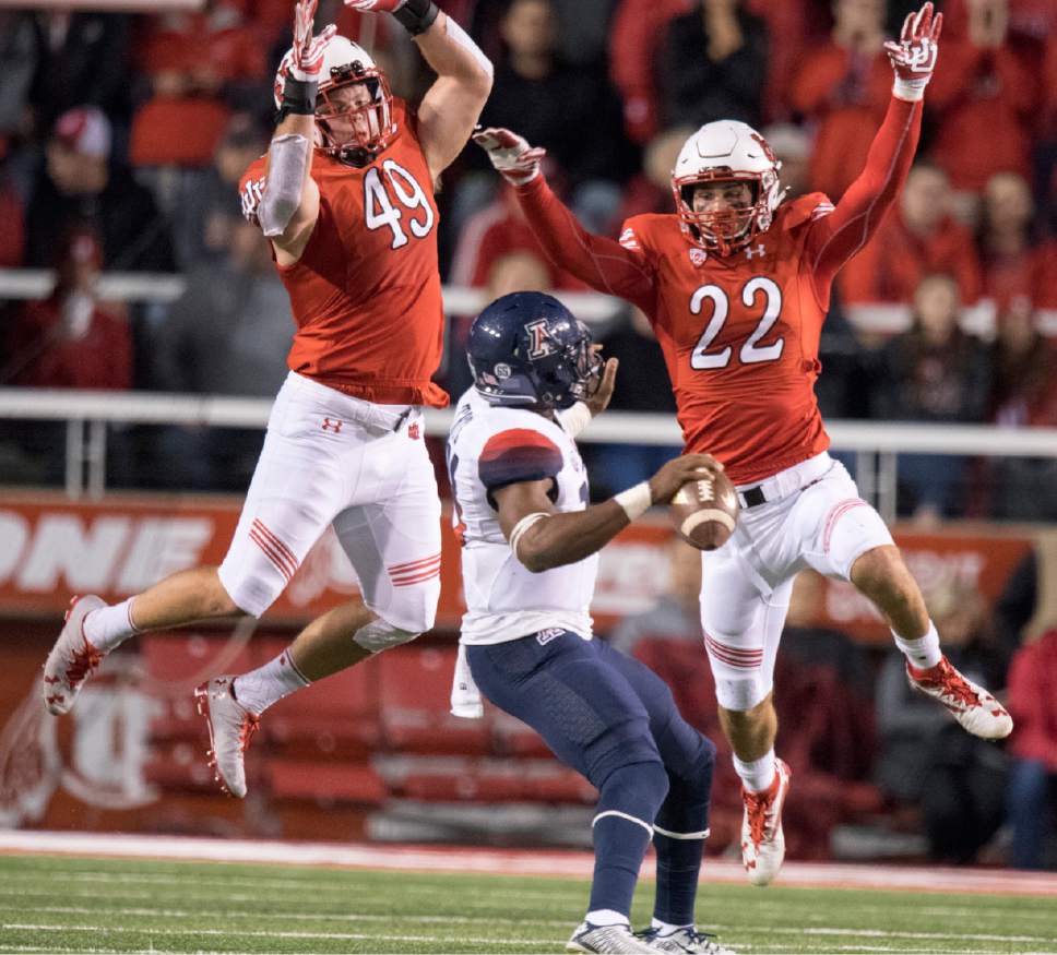 Rick Egan  |  The Salt Lake Tribune

Utah defensive end Hunter Dimick (49) and  defensive back Chase Hansen (22) put pressure on Arizona Wildcats quarterback Khalil Tate (14) in PAC-12 football action, Utah vs. The Arizona Wildcats, at Rice-Eccles Stadium, Saturday, October 8, 2016.