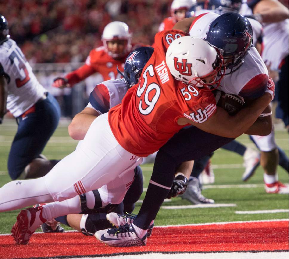 Rick Egan  |  The Salt Lake Tribune

Utah Utes defensive tackle Pasoni Tasini (59) throws down Wildcats quarterback Brandon Dawkins (13) in the end zone for a safety, in PAC-12 football action, Utah vs. The Arizona Wildcats, at Rice-Eccles Stadium, Saturday, October 8, 2016.