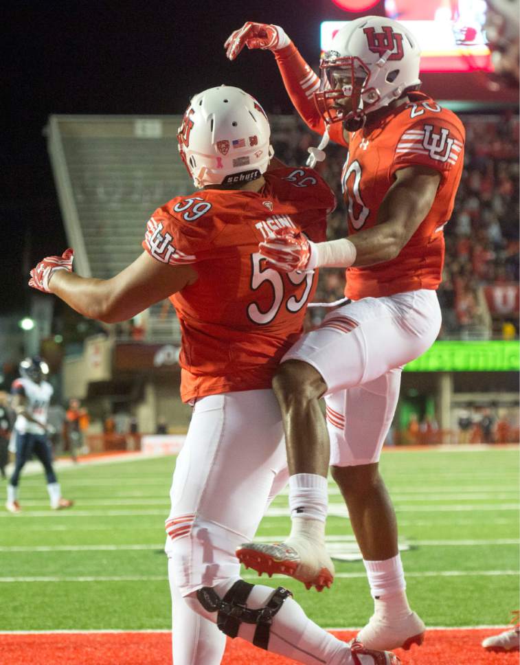 Rick Egan  |  The Salt Lake Tribune

Utah Utes defensive back Marcus Williams (20) celebrates after Utah defensive tackle Pasoni Tasini (59) sacked Wildcats quarterback Brandon Dawkins (13) in the end zone for a safety, in PAC-12 football action, Utah vs. The Arizona Wildcats, at Rice-Eccles Stadium, Saturday, October 8, 2016.