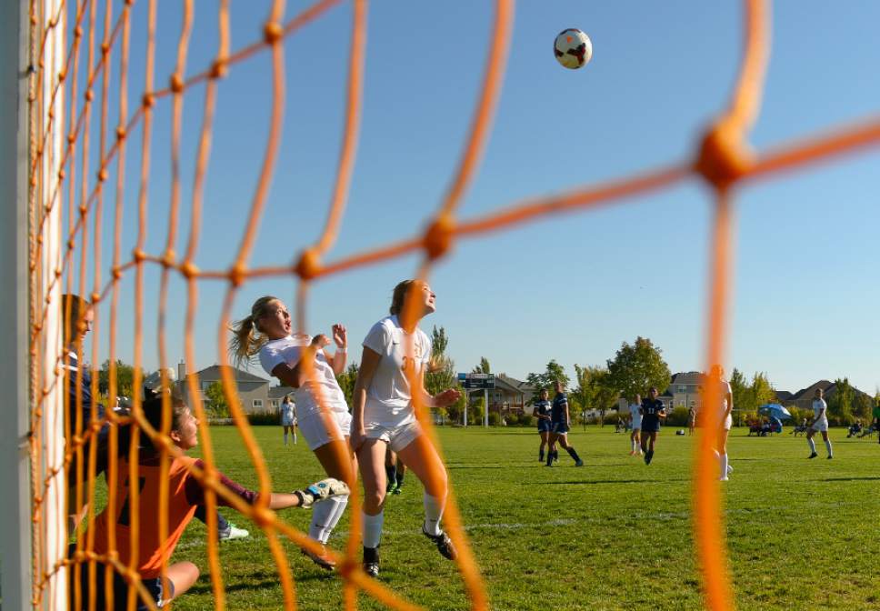 Leah Hogsten  |  The Salt Lake Tribune
Davis' Riley Whitesides watches as teammate Kate McMaster heads a goal into the net. Davis High School girls' soccer program, currently ranked No. 1 nationally by USA Today, established the new UHSAA record for most consecutive wins with their 37th straight win against Hunter High School 13-0, September 27, 2016.