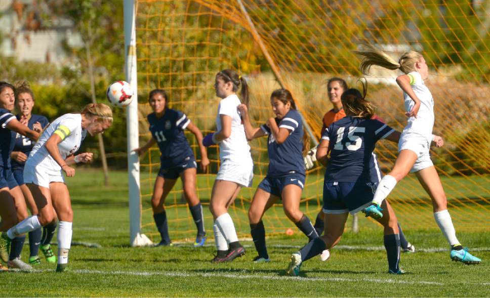 Leah Hogsten  |  The Salt Lake Tribune
Davis' Mikayla Colohan heads in a goal from a corner kick. Davis High School girls' soccer program, currently ranked No. 1 nationally by USA Today, established the new UHSAA record for most consecutive wins with their 37th straight win against Hunter High School 13-0, September 27, 2016.