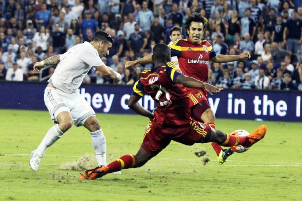 Kit Doyle  |  Special to the Salt Lake Tribune

Sporting Kansas City forward Dom Dwyer, left, shoots past Real Salt Lake defender Aaron Maund.  The shot bounced off the post and Sporting scored on the rebound Wednesday night, August 12, 2015, at Sporting Park.