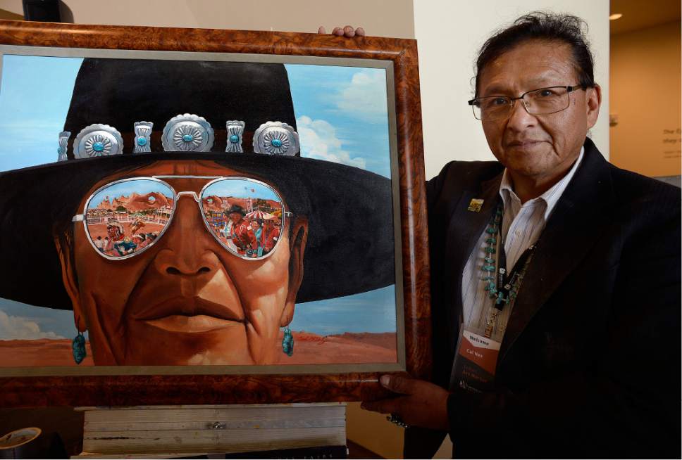 Scott Sommerdorf   |  The Salt Lake Tribune  
Artist Cal Nez with his painting "Navajo Nation Fair - 1989" at the Natural History Museum on Saturday.