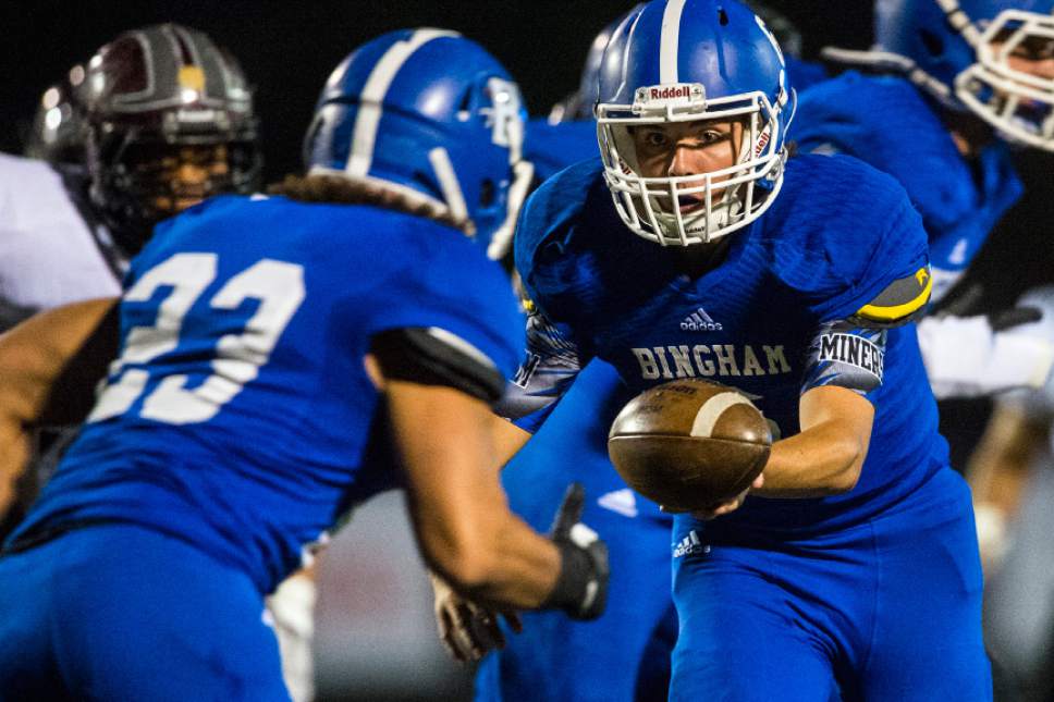 Chris Detrick  |  The Salt Lake Tribune
Bingham's Matt Degn (6) hands off to Bingham's Jahvontay Smith (23) during the game at Bingham High School Thursday October 13, 2016.