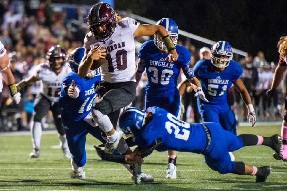 Chris Detrick  |  The Salt Lake Tribune
Jordan's Crew Wakley (10) scores a touchdown past Bingham's Tongi Langi (10) and Bingham's Daniel Loua (20) during the game at Bingham High School Thursday October 13, 2016.