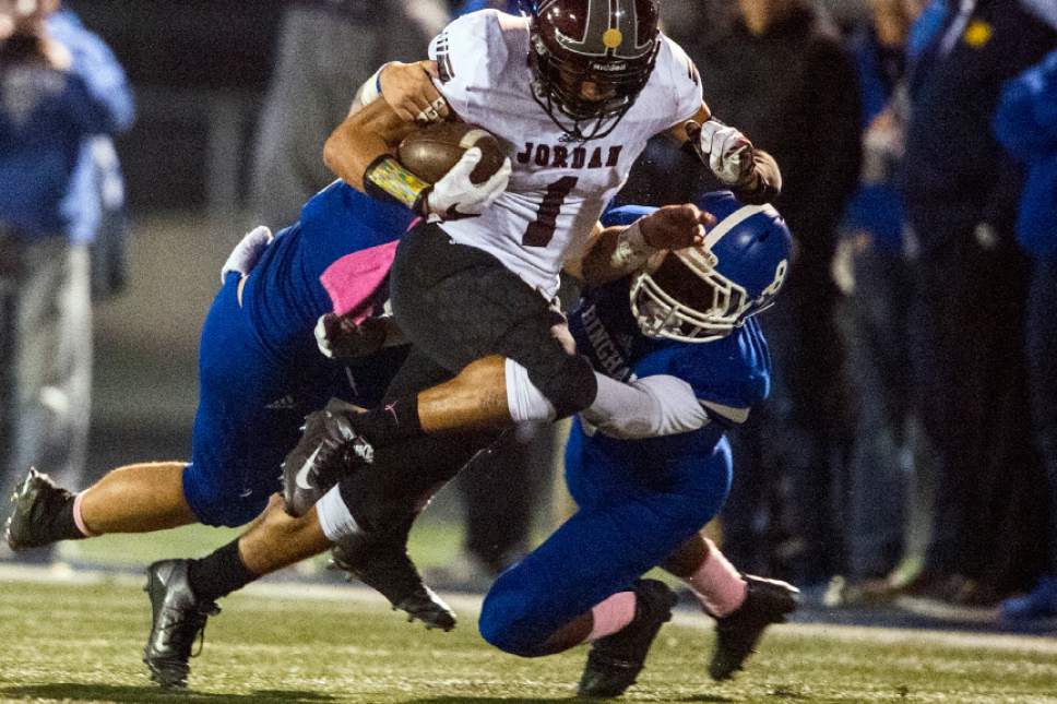 Chris Detrick  |  The Salt Lake Tribune
Bingham's Saleka Ataata (28) and Bingham's Jaylen Vickers (8) tackle Jordan's Isiah Jackson (1) during the game at Bingham High School Thursday October 13, 2016.