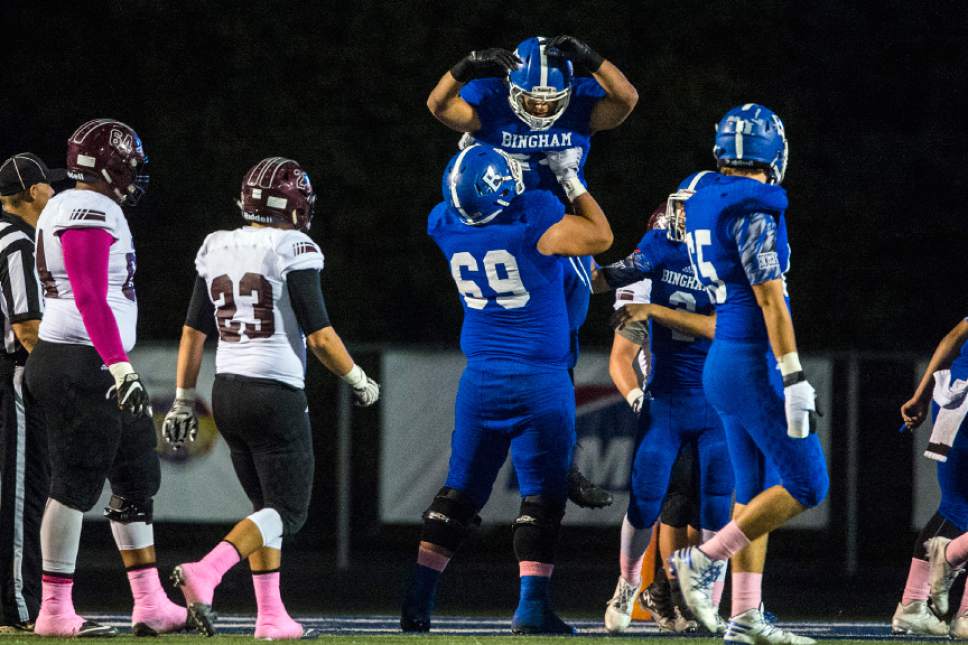 Chris Detrick  |  The Salt Lake Tribune
Bingham's Jahvontay Smith (23) is lifted up by Bingham's Tavian Myers (69) after scoring a touchdown during the game at Bingham High School Thursday October 13, 2016.