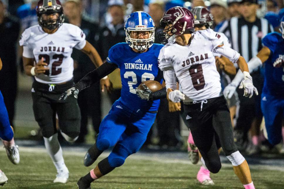 Chris Detrick  |  The Salt Lake Tribune
Bingham's Daniel Loua (20) runs past Jordan's Andrew Kafentzis (8) during the game at Bingham High School Thursday October 13, 2016.