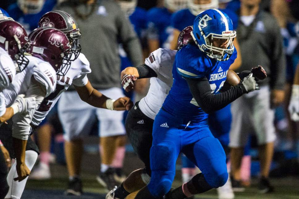 Chris Detrick  |  The Salt Lake Tribune
Bingham's Daniel Loua (20) runs past Jordan's Preston Hagen (6) during the game at Bingham High School Thursday October 13, 2016.