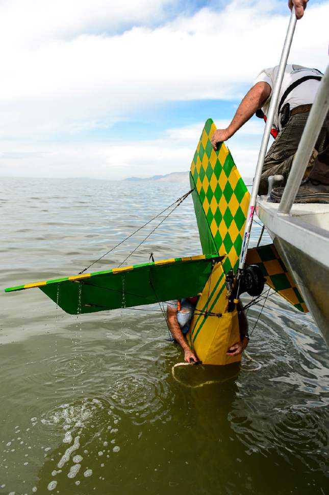 Trent Nelson  |  The Salt Lake Tribune
Fred Austin of the Emergency Response Team for the Great Salt Lake work to attach an anchor and buoy to a fixed-wing plane sites the Great Salt Lake where it crashed Thursday October 13, 2016.