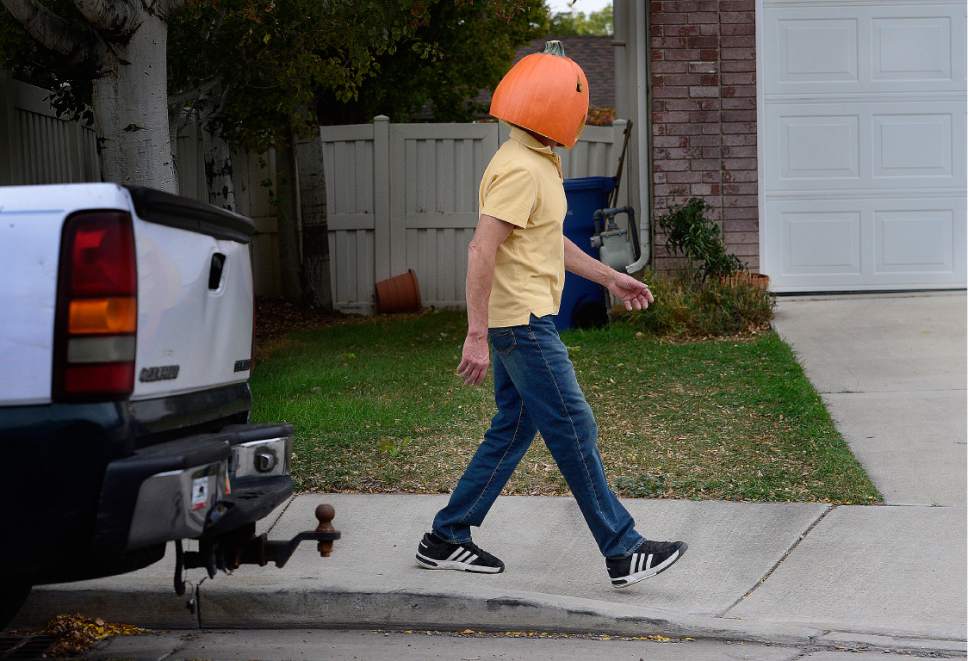 Scott Sommerdorf   |  The Salt Lake Tribune  
A man with a fake pumpkin on his head was spotted walking in the area of the Starks Funeral Parlor on 900e, Friday, October 14, 2016.
