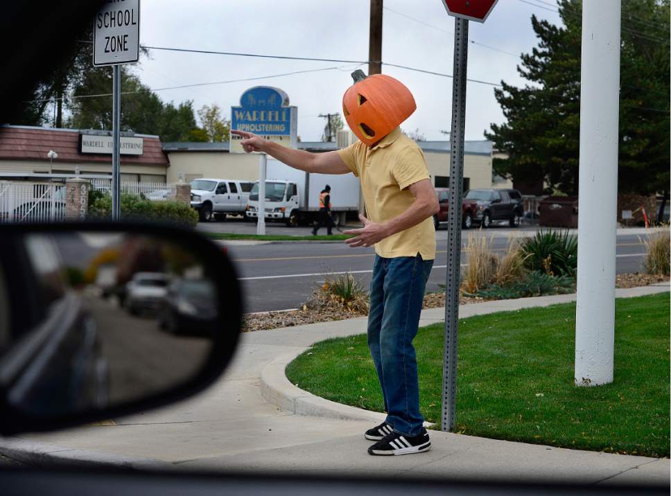 Scott Sommerdorf   |  The Salt Lake Tribune  
A man with a fake pumpkin on his head was spotted walking in the area of the Starks Funeral Parlor near 3600 South and 900 E. on Friday.