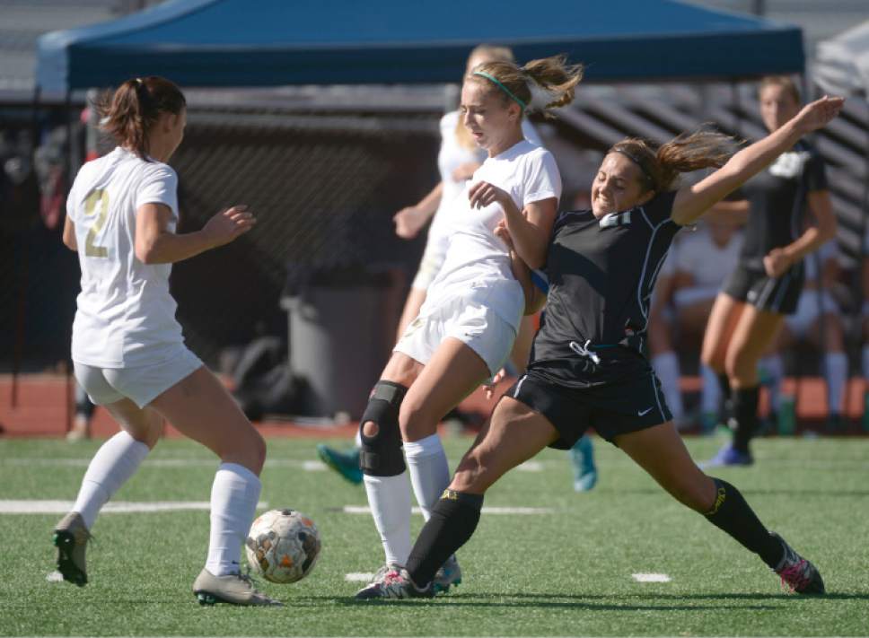 Leah Hogsten  |  The Salt Lake Tribune
Stansbury's Paige Boyce foots the ball from behind Logan's Kennedy Michel.  Logan High School girls soccer team defeated Stansbury High School 5-3 during their state 3A quarterfinals game at Logan, October 15, 2016.