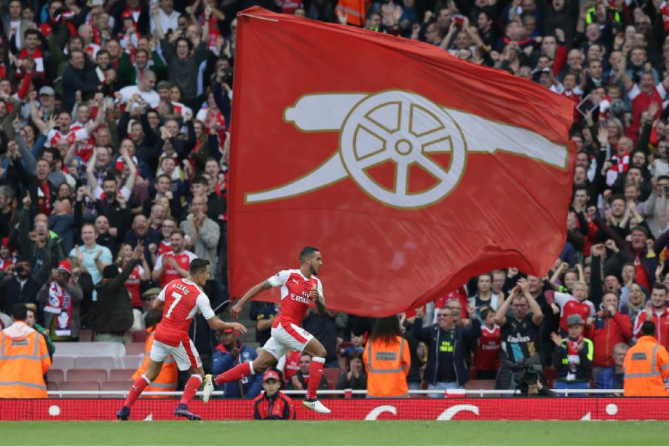 Arsenal's Theo Walcott, right, celebrates after scoring his team's second goal during the English Premier League soccer match between Arsenal and Swansea City at The Emirates Stadium in London, Saturday Oct. 15, 2016. (AP Photo/Tim Ireland)