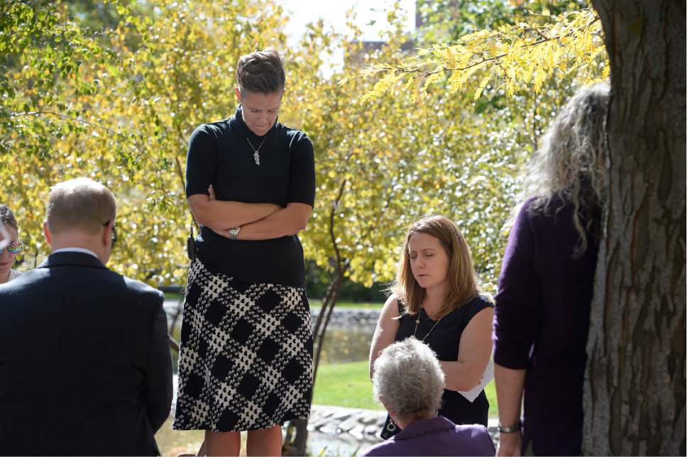 Scott Sommerdorf   |  The Salt Lake Tribune  
Debra Jenson, left, stands on a bench in City Creek Park and leads the Ordain Women group in a prayer before their march to the LDS Church Administration Building to request a meeting with a general authority, Saturday, October 1, 2016.
